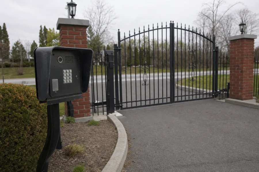 Gate operator, arm and control box on a driveway gate in Omaha, NE