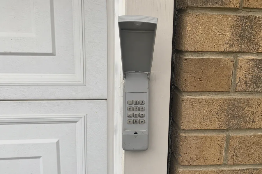 An outdoor keypad beside a garage in Omaha, NE
