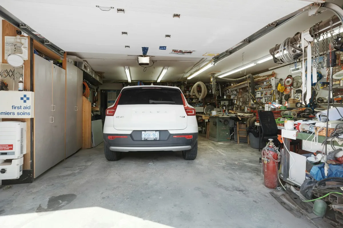 Garage interior with a parked car and a wall of tools